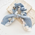Detailed view of a blue floral satin scrunchie with bunny ear knot on a stone pedestal - Rabbit Ear Bow / Light Blue Floral