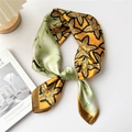 Elegant mango yellow and green satin square scarf with leaf print tied on a wood base - Yellow Maple Leaf Pattern