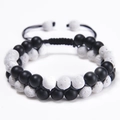 Macro detail of 8mm double-layered lava and emperor stone beads with woven drawstring - Black Matte + White Lava Rock