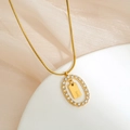Detailed close-up of gold snake chain necklace with zircon oval frame and letter I pendant - Letter I
