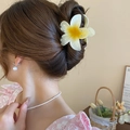 Detail of yellow and white gradient plumeria hair claw clip on a model's hairstyle - Gradient Yellow Lily Claw / Gradient Yellow