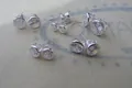 Macro detail of various sizes of round-cut cubic zirconia studs in silver bezel setting - 6mm / Silver Plated White Zirconia