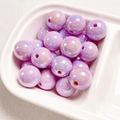 Macro shot of purple iridescent round beads for DIY jewelry making in a white bowl - Pink Purple