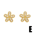 Minimalist gold flower stud earrings with sparkling cubic zirconia and granulation details - Flower