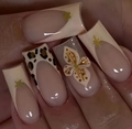 Macro view of brown leopard print press-on nails with 3D white floral and gold star accents - Nude Pink 3D Floral Style (AW399) / Black Jelly Glue + Nail File