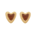 French vintage heart studs with woven gold texture and amber resin center on white background - Brown