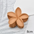 Detail of 8cm orange matte flower hair claw clip with floral petals on stone surface - Caramel Matte 8cm