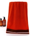 Thick orange cotton face towel with dark brown stripes and plush absorbent texture - Cotton Classic Orange (Towel)