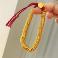 Detail of beaded bracelet with red cord featuring a gold charm engraved with Fu character - Red Rope Golden Coiled (No Pendant) Bracelet