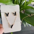 Ensemble de bracelets dorés avec pendentifs papillon noirs sur carte blanche - 3039
