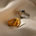 Detailed close-up of gold and silver snake style open rings on soft silk fabric - Polished Minimalist Style (G10297143)