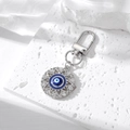 Detail of silver evil eye keychain with blue enamel inlay and sparkling rhinestones - Silver Pointed Hollow Evil Eye