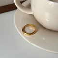 Close-up of matte gold open ring with S9999 engraving on a ceramic saucer edge - Adjustable Plain Band / Matte Gold