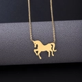 Detailed view of a golden unicorn pendant necklace displayed on a professional gray stand - Necklace Bracelet Earrings Set / Gold