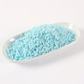 Artificial light blue sprinkle particles for DIY crafts displayed in a white ceramic dish - Blue Hazelnut / 500g