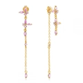 Macro view of butterfly earrings with pink zircon stones and long gold tassels - Pink Zirconia