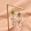 Elegant baroque pearl drop earrings with floral enamel in gold finish on silk display - Baroque Pearl Small Flower Dangle