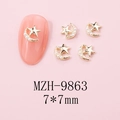 Macro detail of 7x7mm gold star nail charms with pearls on pink background - MZH-9863 (7*7mm)