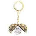 Detail showing an open sunflower keychain with 'She believed she could so she DID' engraving - T00003 Gold Sunflower Silver Disc (She believed she could so she did)