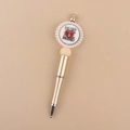 Close-up of golden beaded pen featuring a cartoon highland cow and Moody text detail - Highland Cow/Gold Barrel