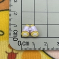 Miniature purple telescope charm on a centimeter ruler grid showing its tiny size - Mini Telescope