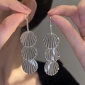 Detail of silver long drop earrings with triple disc design and radial ripple texture - Three-layer Disk / Silver