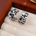 C-shaped hoop earrings with black and white woven leather texture on a display stand - Gold & Black & White (Zebra)