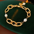 Close-up of gold plated chunky chain bracelet with freshwater pearls on green velvet - Gold Regular Style