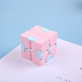 Pink and light blue infinity cube fidget toy for stress relief in a foldable design - Pink