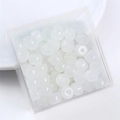 Macro detail of 8x6mm white square glass faux jade beads in a clear plastic box - Barrel Bead 8x6mm / White