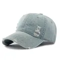 Distressed light blue denim baseball cap with vintage frayed holes and retro street style - Light Blue