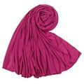 Macro shot of draped deep magenta jersey fabric texture with elegant spiral folds - Purple Fuchsia