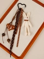 Detail view of handmade plush bunny and brown polka dot heart charm on wood tray - White Rabbit Style