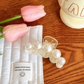 Elegant clear hair claw clip with gradient white faux pearls on a wooden table - No. 2 Five Pearls Medium 7cm