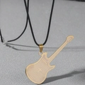 Detailed view of a golden guitar pendant with engraved cross and Spanish prayer text - Music Gold