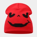 Close-up of red knitted beanie featuring black spooky pumpkin smile jacquard pattern - Style B Red (Funny Jacquard)