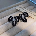 Macro detail of leaf-shaped earrings featuring black rectangular gems and micro zircon - Leaf Design / Black Zircon With Silver Base