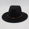 Close-up of brown leather hat band with silver metal stars and studs on a black fedora hat - One Size / Black