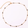 Close-up of gold-plated chain with black and white evil eye beads and adjustable clasp - Black Necklace