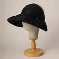 Detail of elegant black mesh sun hat featuring tiered ruffled brim and gold metal charm - M (56-58cm) / Black