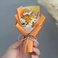 Close-up of mini dried yellow rose bouquet with white baby's breath in hand - Yellow Rose (Orange Wrapping)