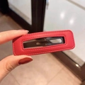 Detailed close-up of a red rectangle PU leather hair clip with fine stitching detail - Red