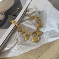 Double-layered 18K gold plated titanium steel bracelet featuring multiple heart charms - Gold