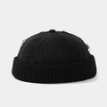 Detail of distressed ripped edges on a black retro docker hat with ribbed knit cuff texture - One Size / Black