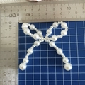 Detail of white faux pearl bow ornament with hanging beads and 8cm scale reference - Alternating Pearl Medium