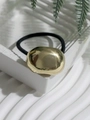 Close-up of minimalist gold irregular metal block on a black elastic hair tie - Style 7 (Gold Irregular Metal Block)