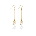 Close-up of long Christmas earrings featuring cute snowman and white snowflake charms - Long Snowman Chain Earring