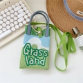 Detailed close-up of a green and blue knitted Grass Land crossbody phone bag with texture - Landscape Grass land Green Blue