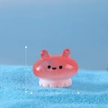 Miniature pink resin octopus figurine with translucent jelly texture on blue sand - No. 3 Jellyfish