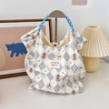 Detail of quilted canvas tote with bear print, blue rope handle and sozakka label - Diamond Bear